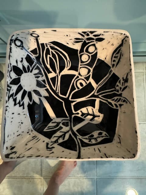 Square ceramic bowl with a bold black and white hand-painted botanical and floral design.